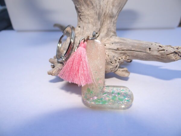 Porte clés lettre "L" transparent avec pompon rose